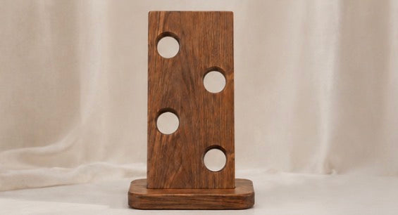 Front view of the acacia wine bottle holder showing its four holes