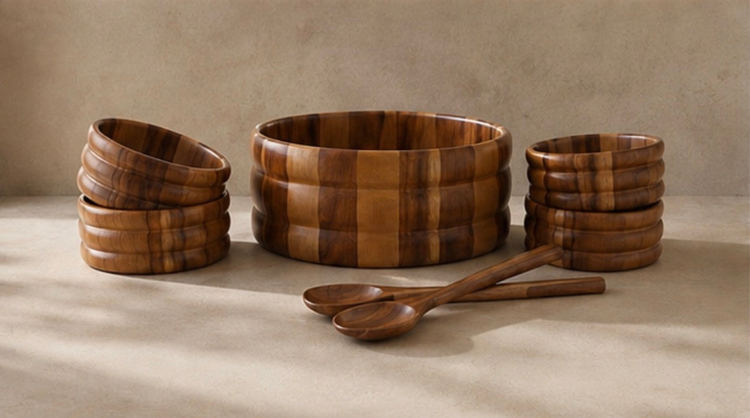 7-piece acacia salad bowl set on a cream counter: large bowl, stacked individual bowls and two servers
