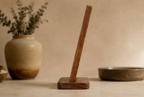 Side view of the acacia wine bottle holder, the board angled on its base