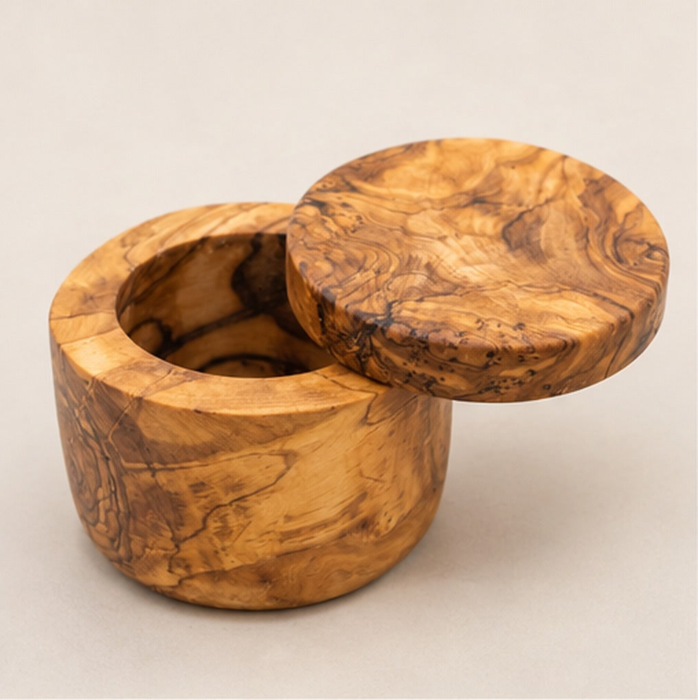 Olive wood salt cellar with the swivel lid turned aside