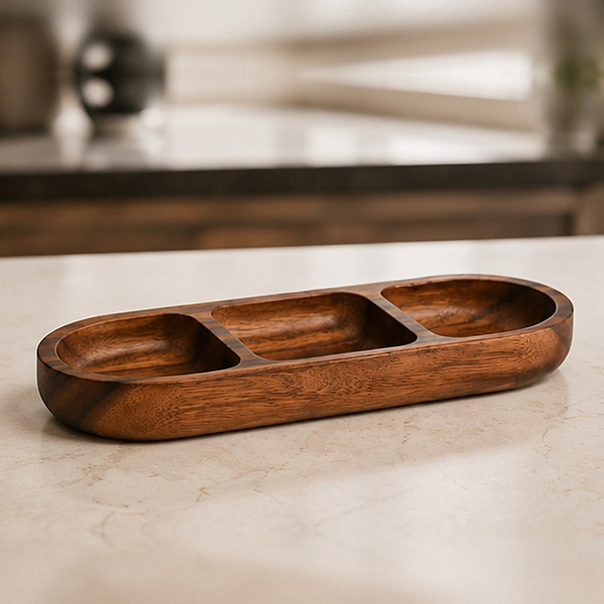 Empty acacia wood snack bowl with three compartments, on a stone countertop