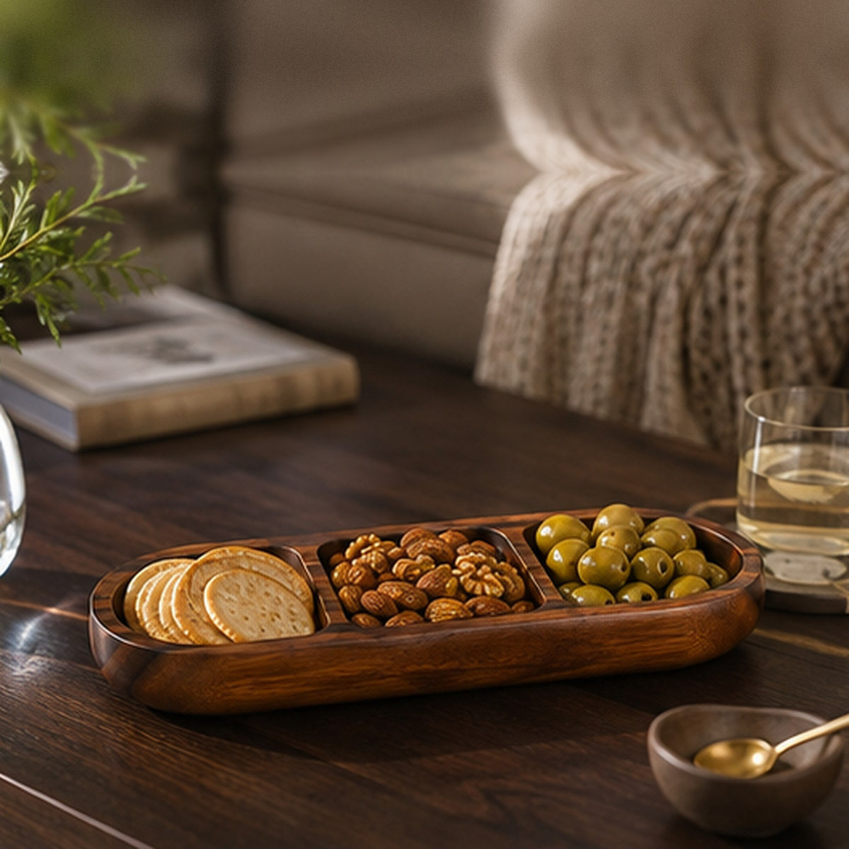 Acacia snack bowl with crackers, nuts and olives on a coffee table