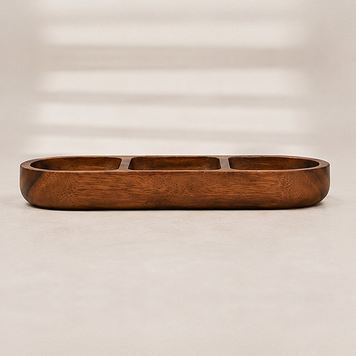 Side view of the acacia snack bowl, showing its low rounded profile